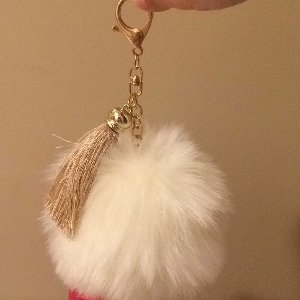 I am selling a white puff ball keychain
